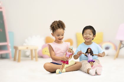 Boy and girl playing with My First Barbie
