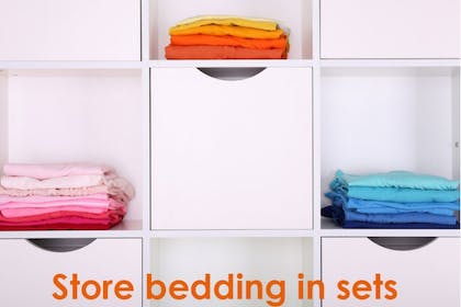 colourful folded bedding on shelves