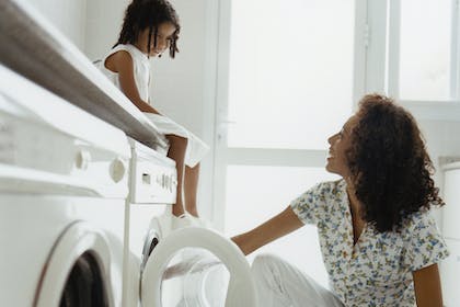 mum and child doing laundry